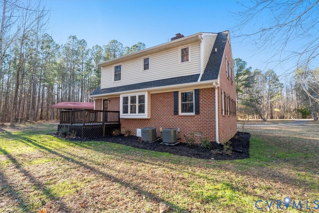 11655 Chatham Road Prince George, VA 23875 - Photo 8 of 48 a backyard of a house with yard table and chairs