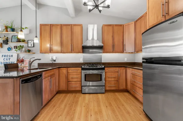 a kitchen with granite countertop a stove and a sink