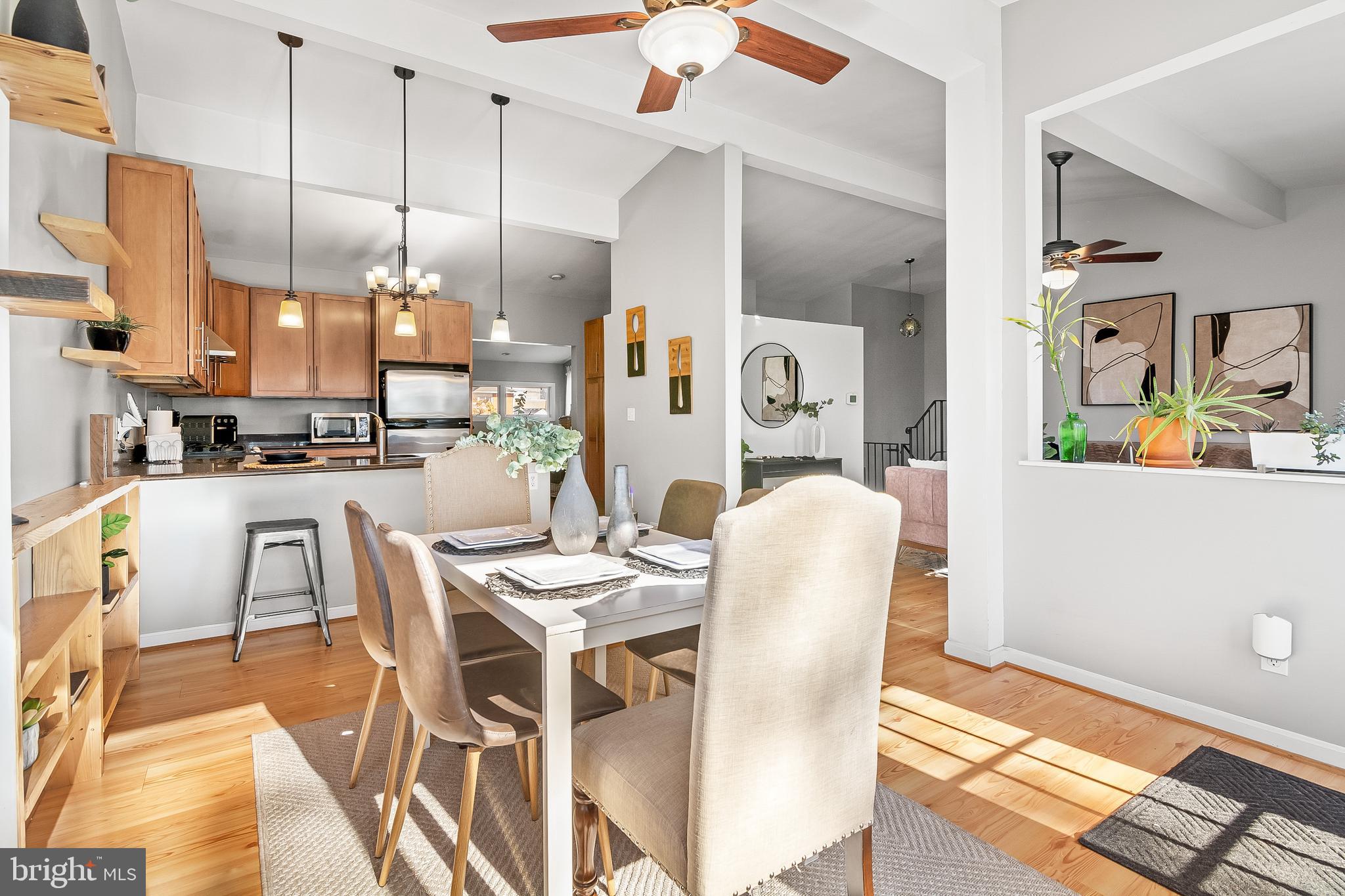 2419 Sylvale Road Baltimore, MD 21209 - Photo 19 of 29 a kitchen with stainless steel appliances kitchen island granite countertop a dining table chairs and a refrigerator
