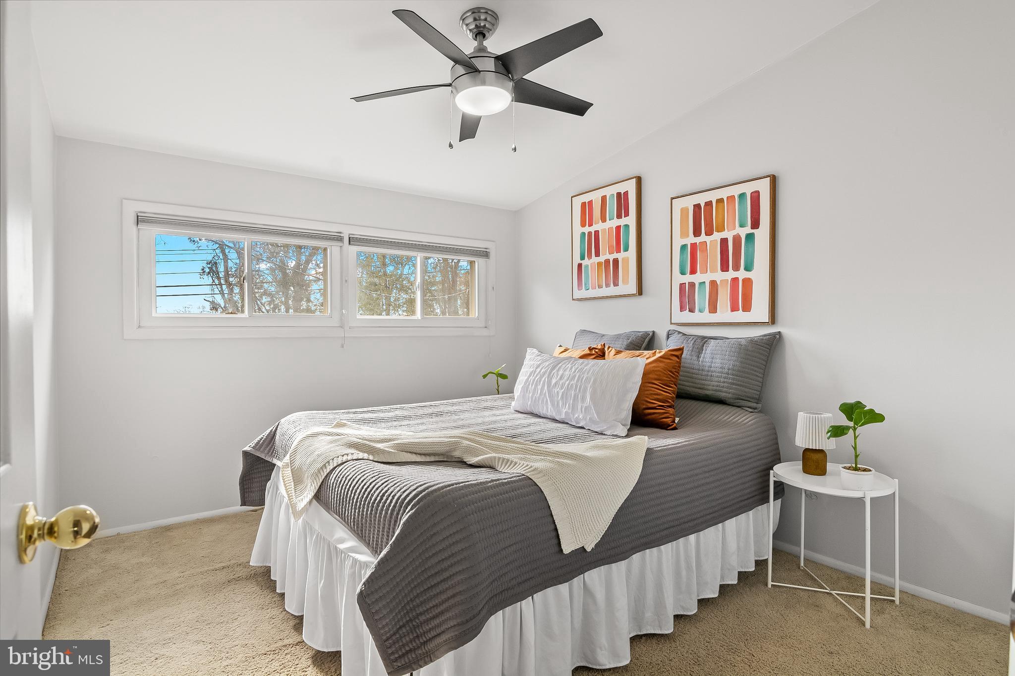 2419 Sylvale Road Baltimore, MD 21209 - Photo 26 of 29 a bedroom that has a bed and a chandelier