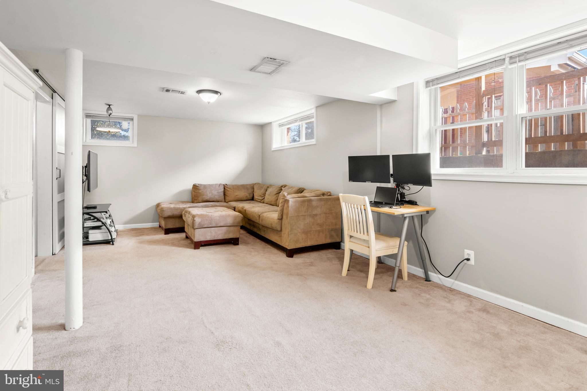 2419 Sylvale Road Baltimore, MD 21209 - Photo 27 of 29 a living room with furniture a flat screen tv and a window