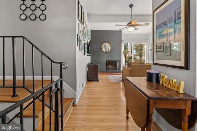 a very nice looking room with wooden floor and furniture