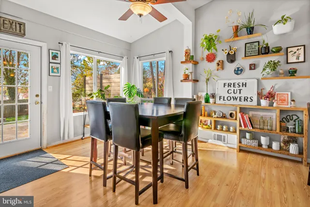 a dining room with furniture and wooden floor