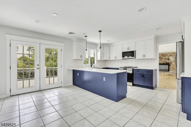 136 Carlough Road Upper Saddle River, NJ 07458 - Photo 11 of 32 a large kitchen with kitchen island granite countertop a large counter top space a sink stainless steel appliances and cabinets