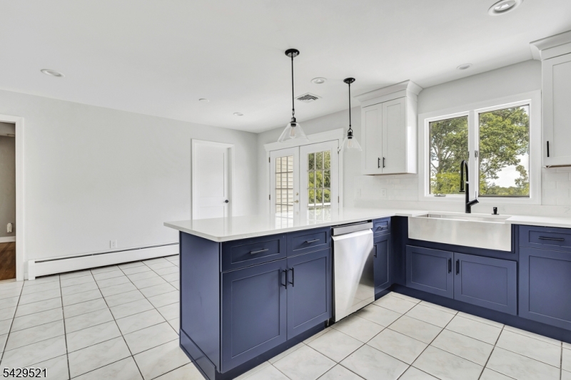 136 Carlough Road Upper Saddle River, NJ 07458 - Photo 12 of 32 a kitchen with stainless steel appliances granite countertop a sink and cabinets
