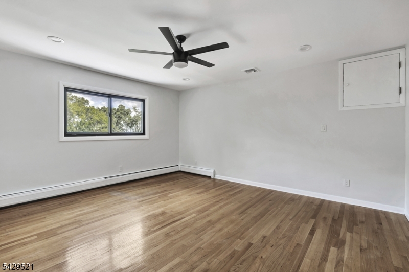 136 Carlough Road Upper Saddle River, NJ 07458 - Photo 14 of 32 a view of a big room with wooden floor closet and windows