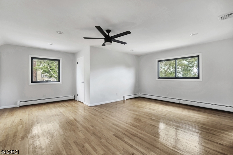 136 Carlough Road Upper Saddle River, NJ 07458 - Photo 18 of 32 a view of empty room with wooden floor and fan