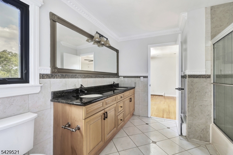 136 Carlough Road Upper Saddle River, NJ 07458 - Photo 19 of 32 a bathroom with a granite countertop sink and a mirror