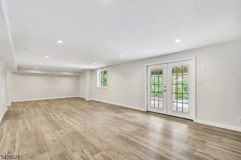 136 Carlough Road Upper Saddle River, NJ 07458 - Photo 23 of 32 a view of an empty room with wooden floor and a window