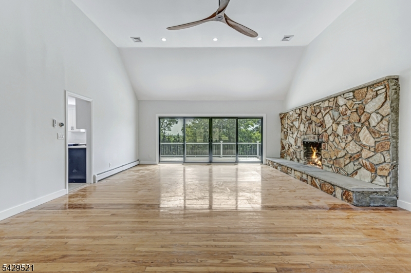 136 Carlough Road Upper Saddle River, NJ 07458 - Photo 5 of 32 a view of an empty room with wooden floor and a window