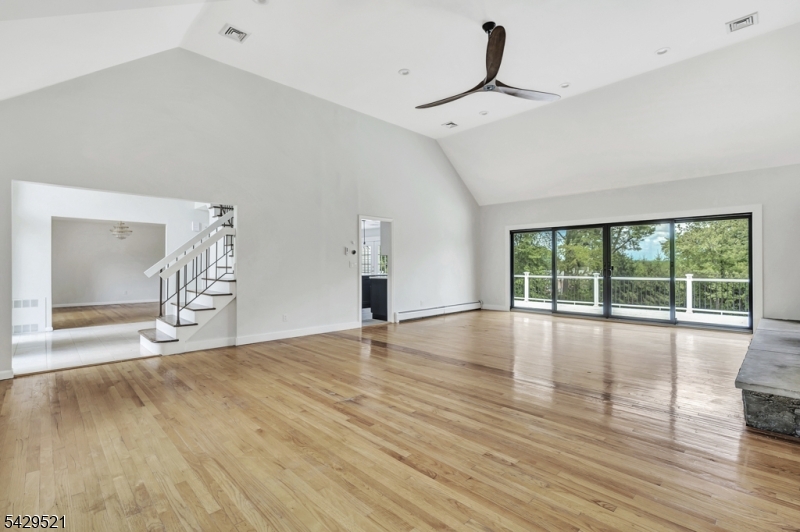 136 Carlough Road Upper Saddle River, NJ 07458 - Photo 6 of 32 a view of empty room with wooden floor and fan
