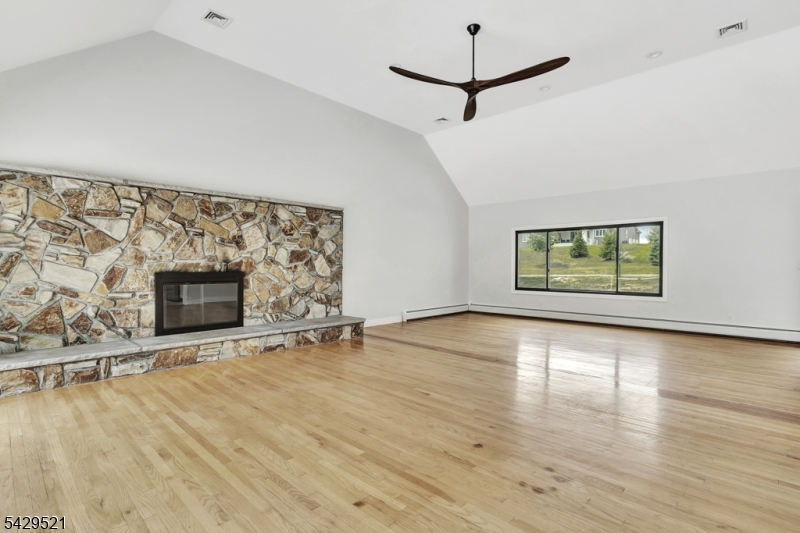 136 Carlough Road Upper Saddle River, NJ 07458 - Photo 7 of 32 a view of an empty room with a window and fireplace
