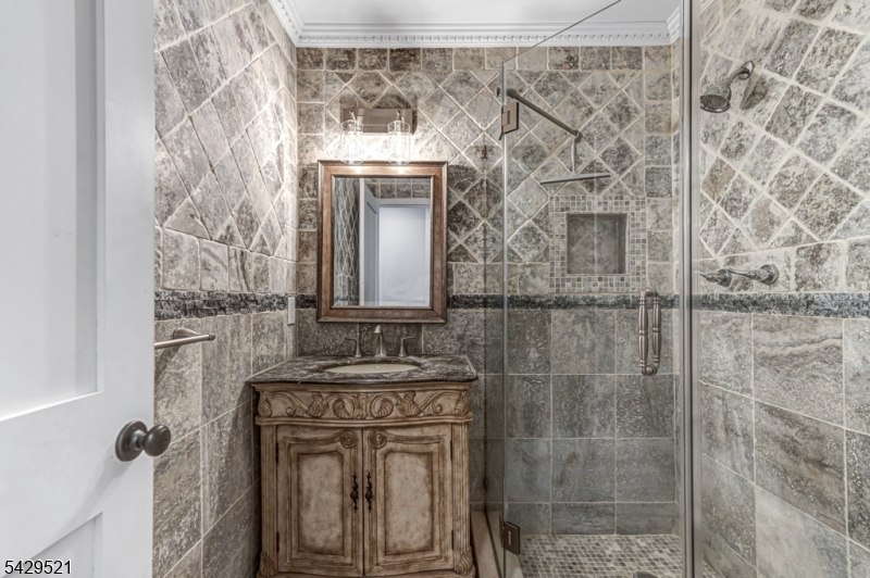 136 Carlough Road Upper Saddle River, NJ 07458 - Photo 9 of 32 a bathroom with a granite countertop shower a mirror and a sink