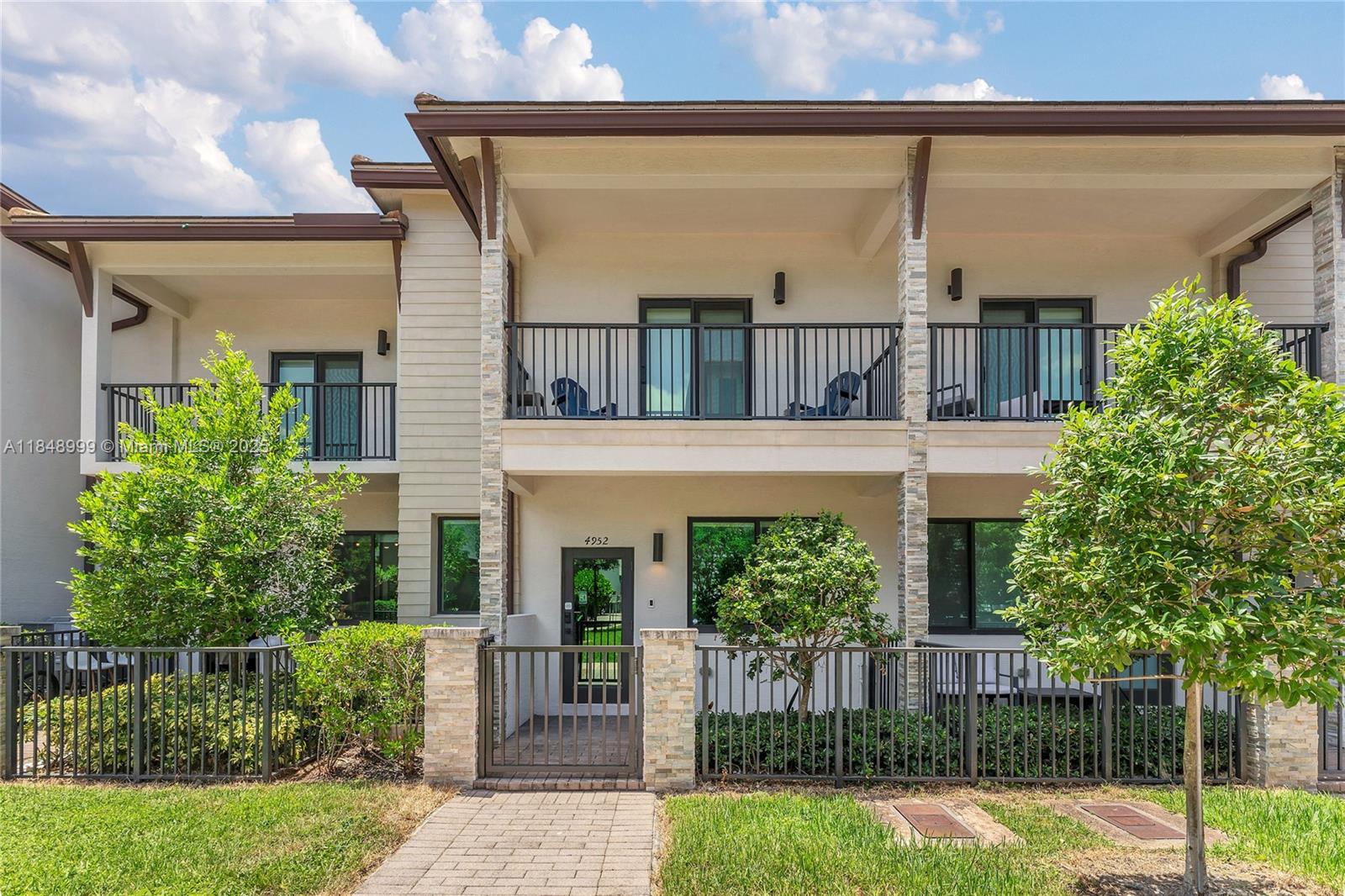 4952 Northwest 83rd Path Doral, FL 33166 - Photo 1 of 49 a front view of a house with a garden