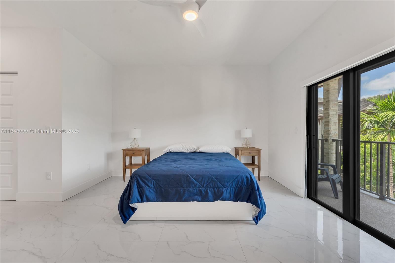 4952 Northwest 83rd Path Doral, FL 33166 - Photo 16 of 49 a bedroom with a bed and a large window