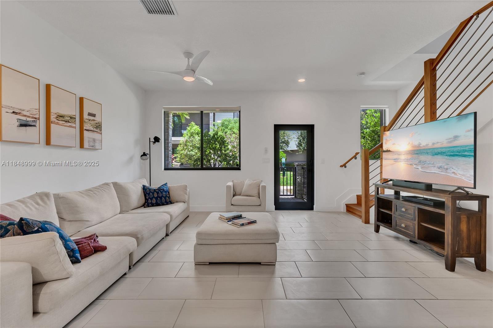 4952 Northwest 83rd Path Doral, FL 33166 - Photo 7 of 49 a living room with furniture and a flat screen tv