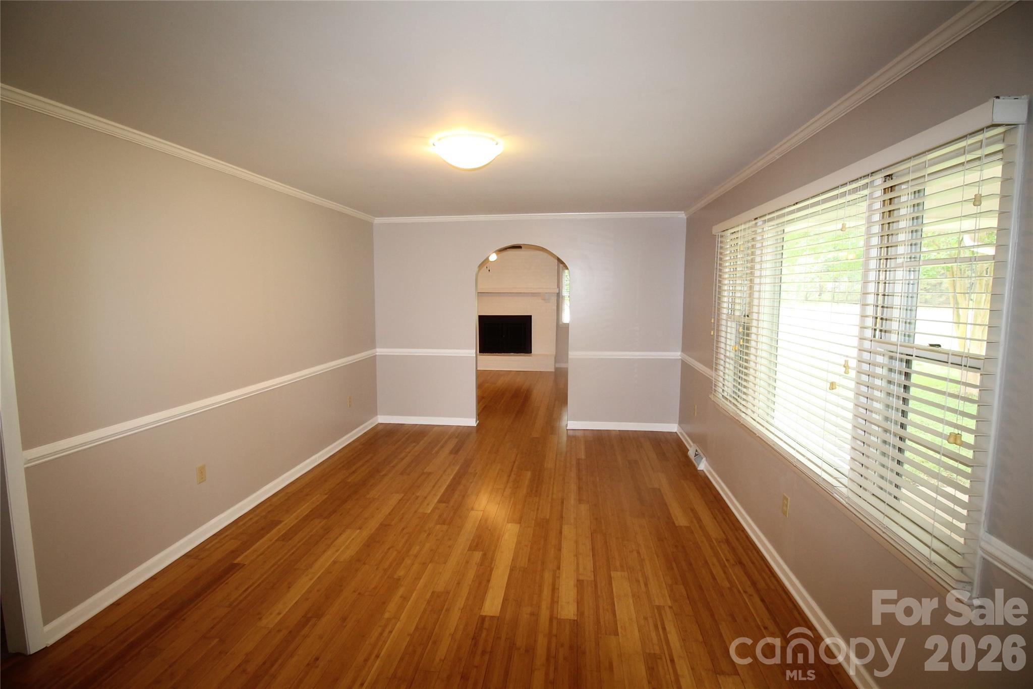 203 Ratchford Farm Road Gastonia, NC 28056 - Photo 15 of 38 a view of empty room with wooden floor and fireplace