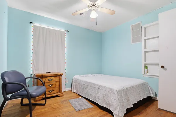 a bedroom with a bed a desk and chair