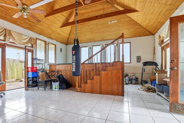a view of a patio with table and chairs under an umbrella