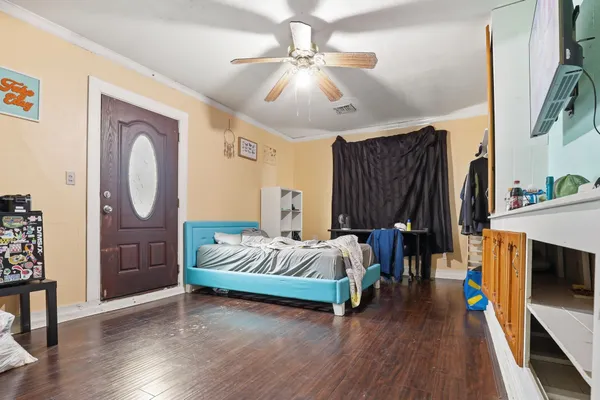 a living room with furniture and a wooden floor