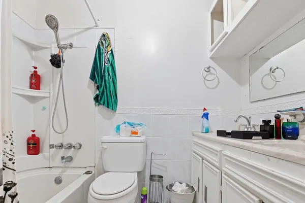 a bathroom with a sink vanity mirror and toilet