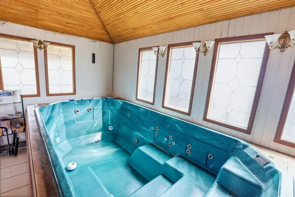 a bathroom with a sink a mirror and next to a window