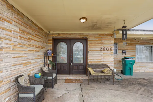 a front view of a house with outdoor seating