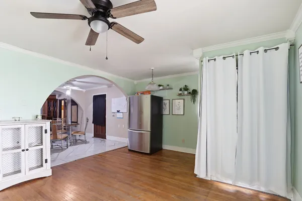 a view of a kitchen with a refrigerator and microwave