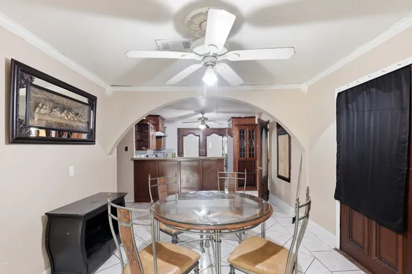 a dining room with furniture and a chandelier