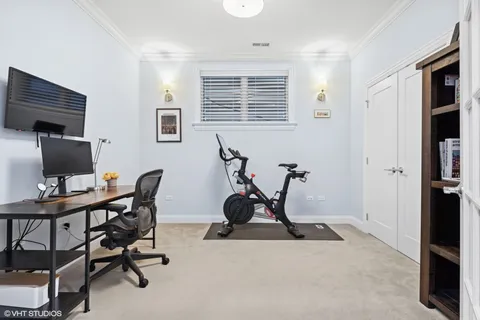 a view of a workspace with furniture and a window