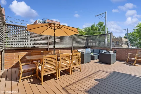 a view of a roof deck with wooden floor