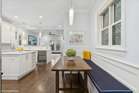 a kitchen with a table chairs sink and cabinets