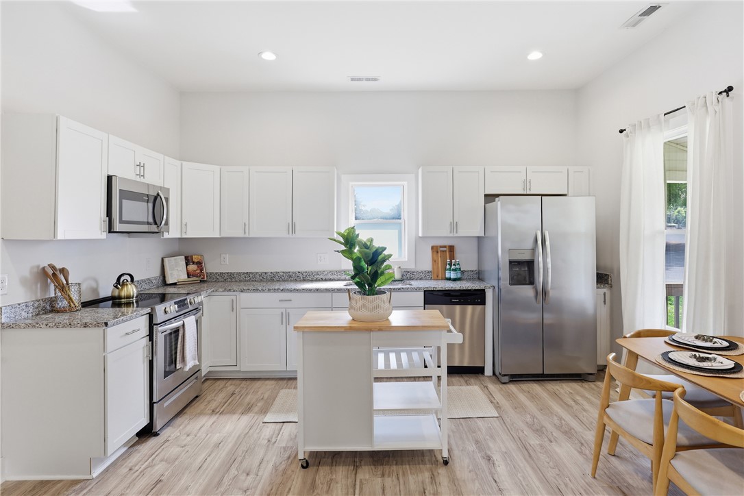 1 Brock Street Pelzer, SC 29669 - Photo 12 of 25 A well-appointed kitchen features stainless steel appliances, granite counters, and ample cabinet storage.