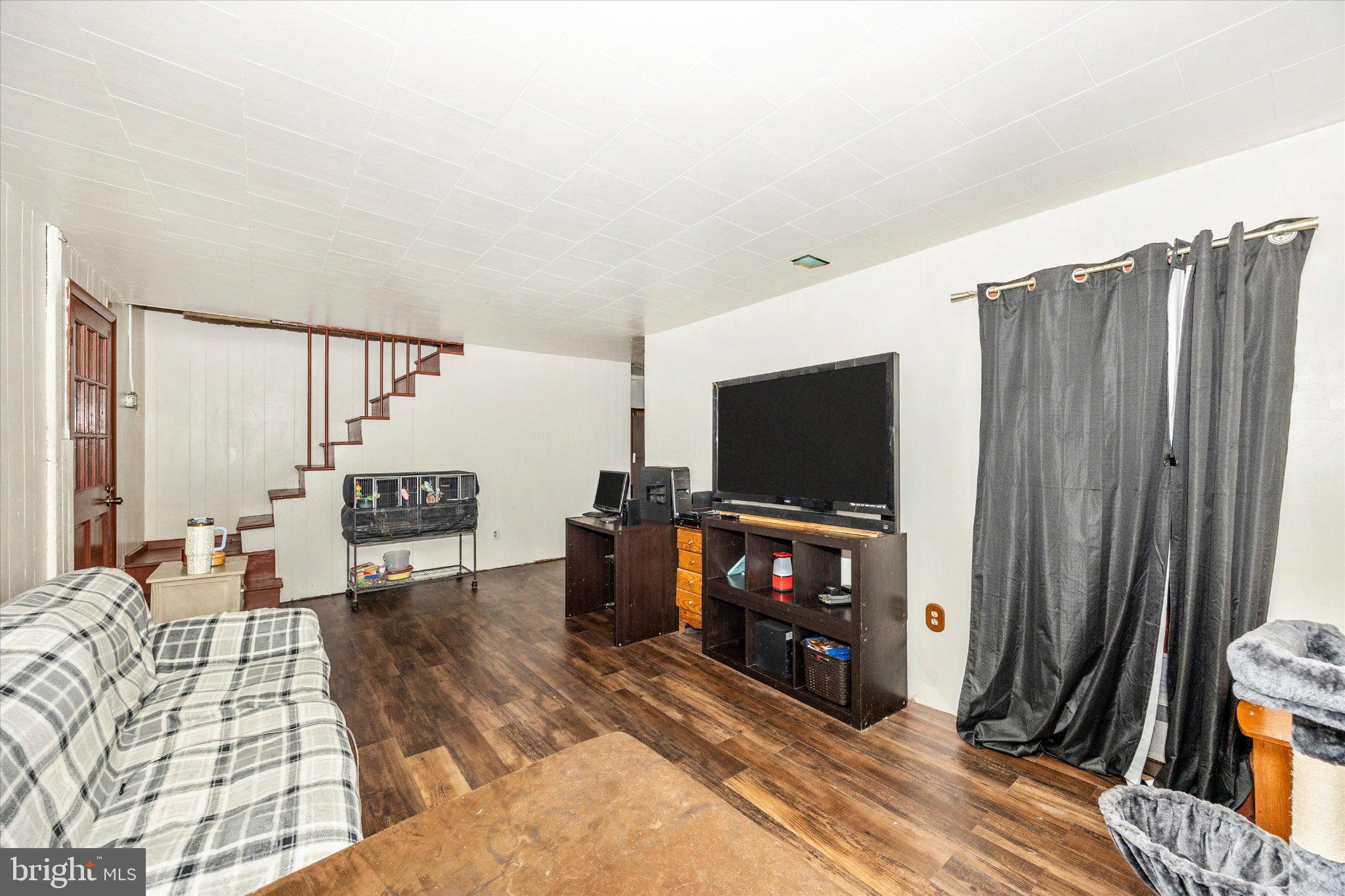 14721 Albert Staub Road Thurmont, MD 21788 - Photo 14 of 46 a living room with furniture and a flat screen tv