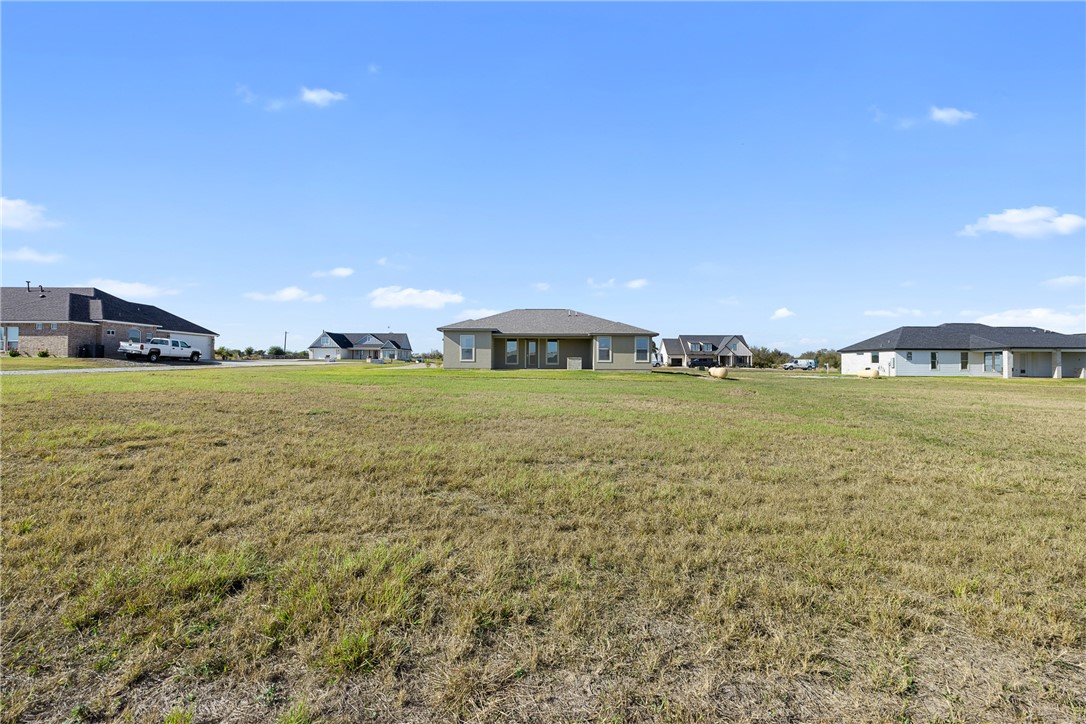 6512 Agave Court Bryan, TX 77808 - Photo 11 of 42 View of grassy yard featuring a residential view