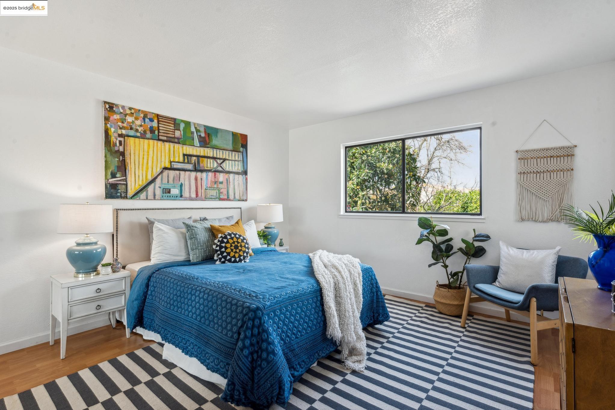 Undisclosed Address San Leandro, CA 94577 - Photo 20 of 50 a bedroom with a bed and wooden floor