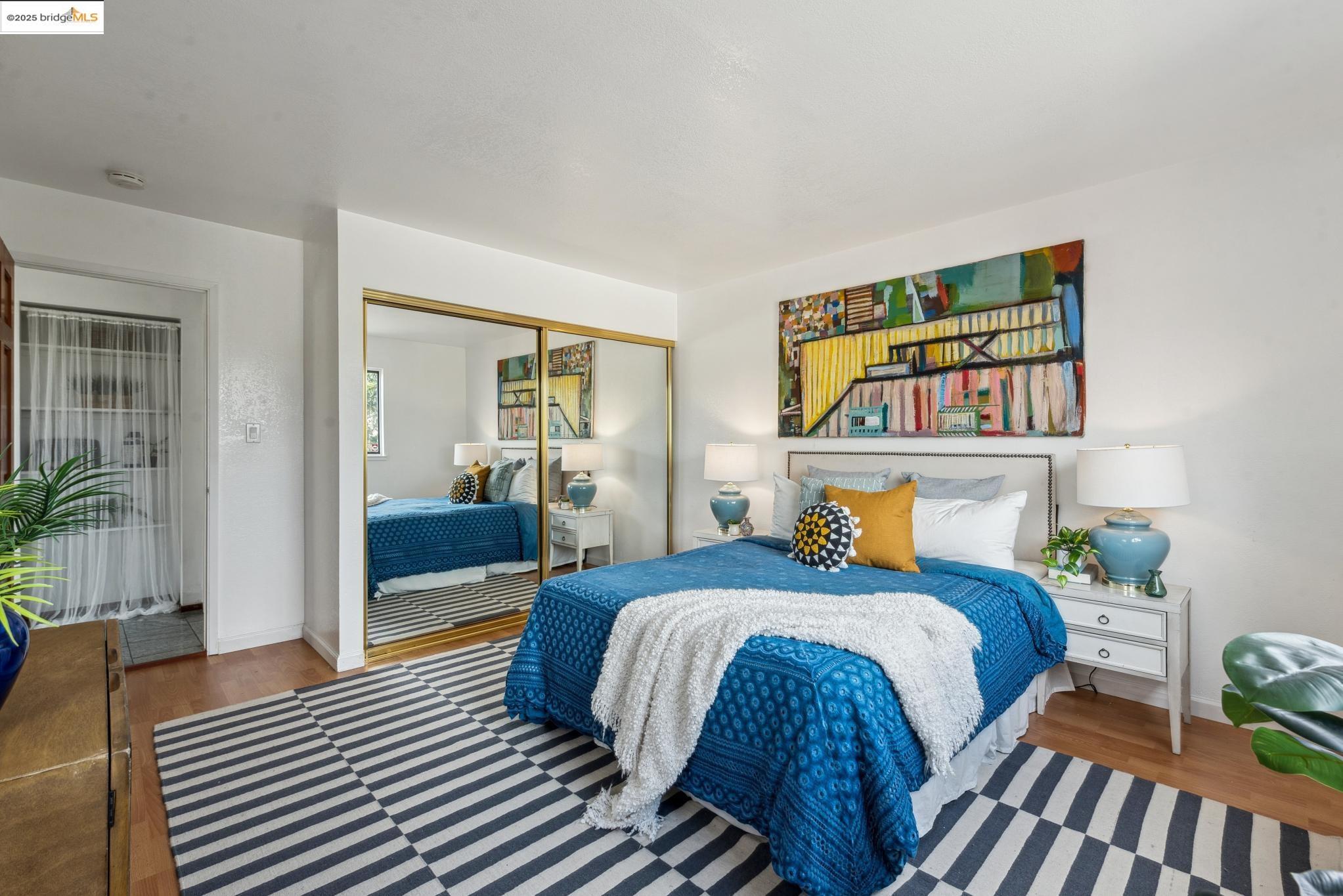 Undisclosed Address San Leandro, CA 94577 - Photo 21 of 50 a bedroom with bed and wooden floor