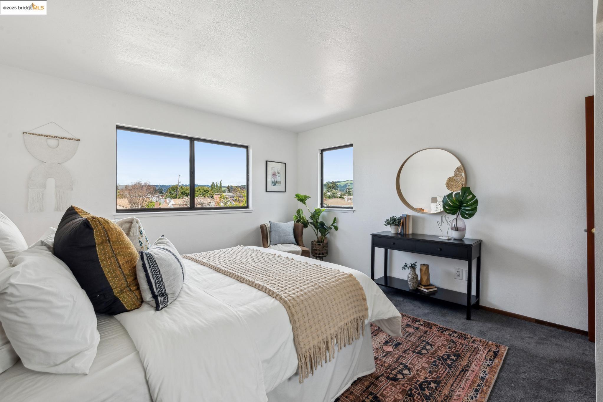 Undisclosed Address San Leandro, CA 94577 - Photo 25 of 50 a bedroom with a bed a mirror and a large window