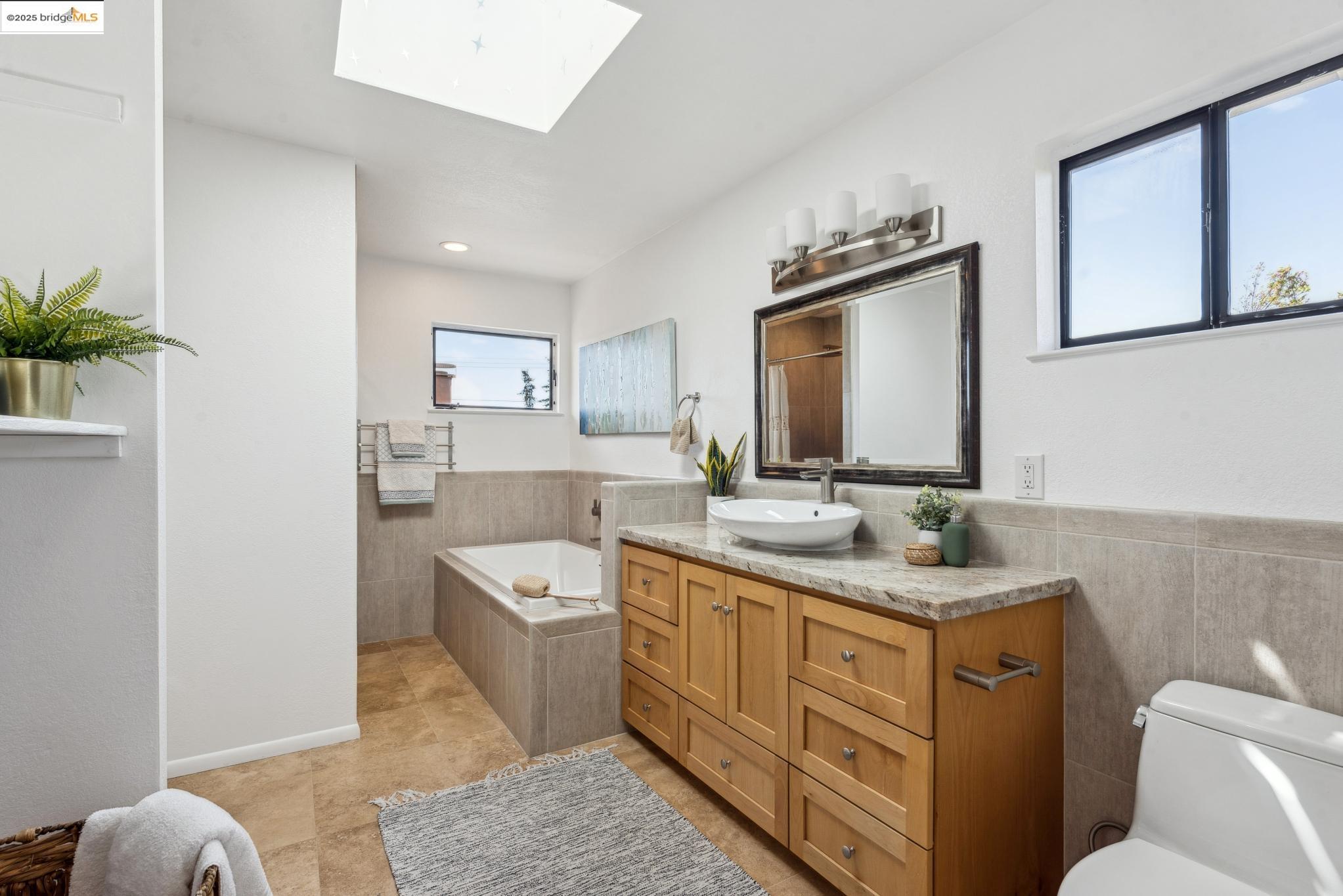 Undisclosed Address San Leandro, CA 94577 - Photo 37 of 50 a bathroom with a granite countertop sink mirror vanity and toilet