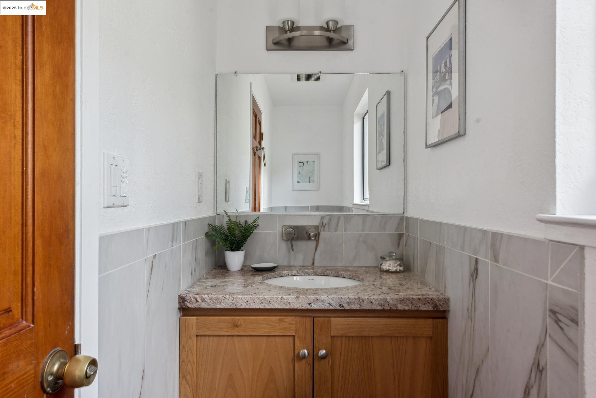 Undisclosed Address San Leandro, CA 94577 - Photo 9 of 50 a bathroom with a granite countertop sink and a mirror