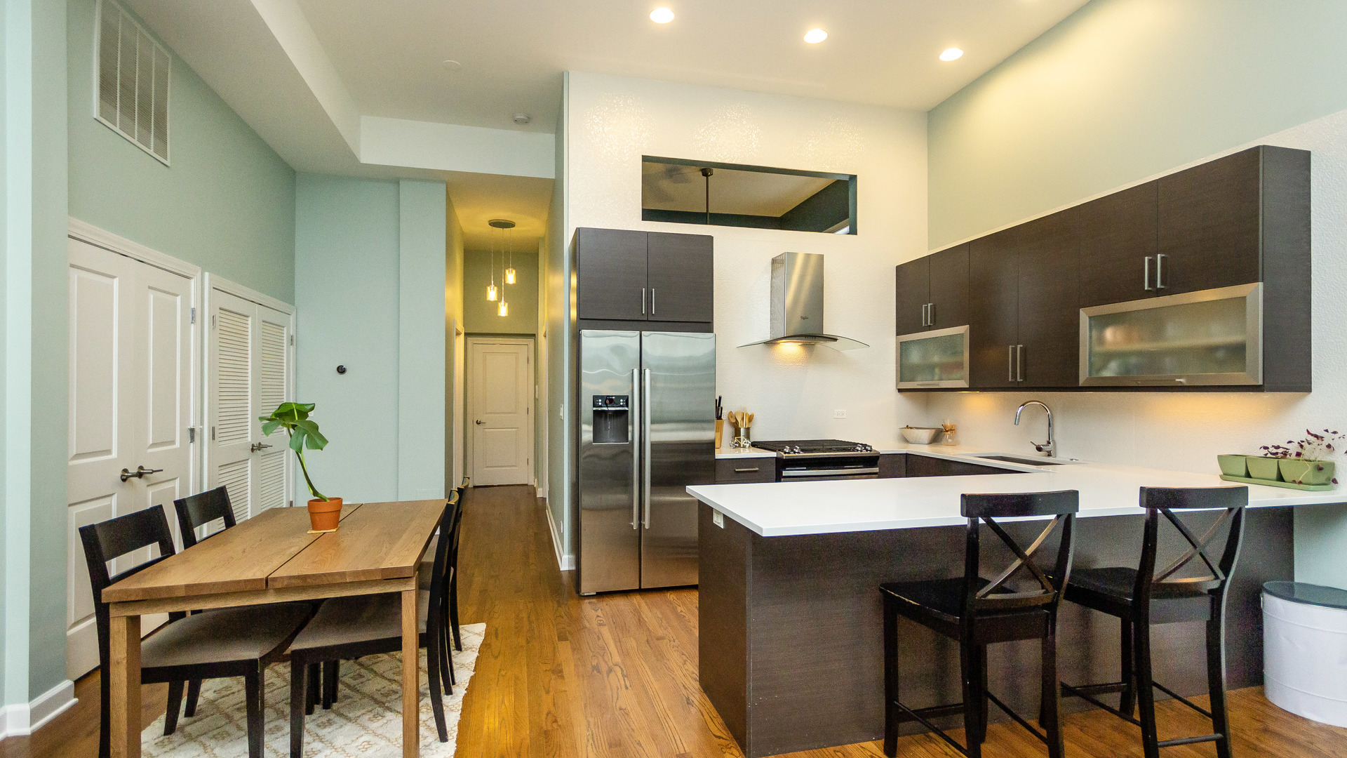 2112 West Rice Street, Unit 1 Chicago, IL 60622 - Photo 6 of 14 a kitchen with a table chairs refrigerator and microwave