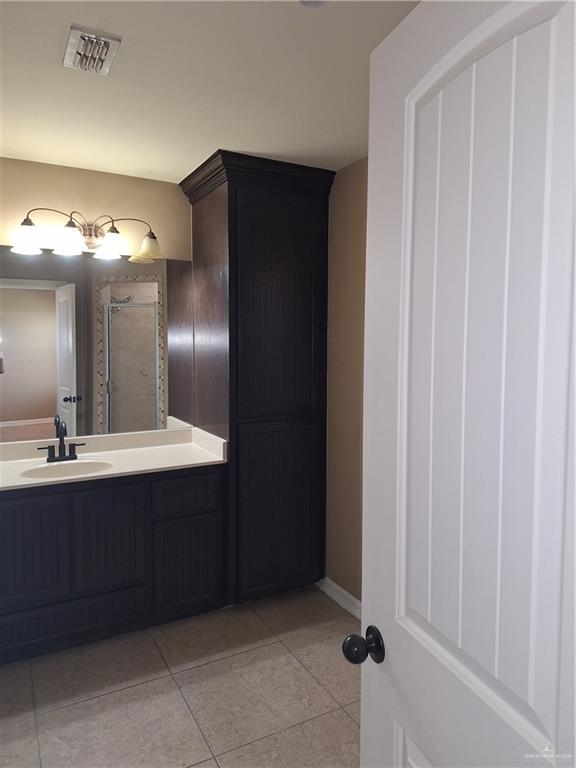2212 North Ruby Street Edinburg, TX 78541 - Photo 11 of 11 Bathroom with light tile patterned floors and vanity