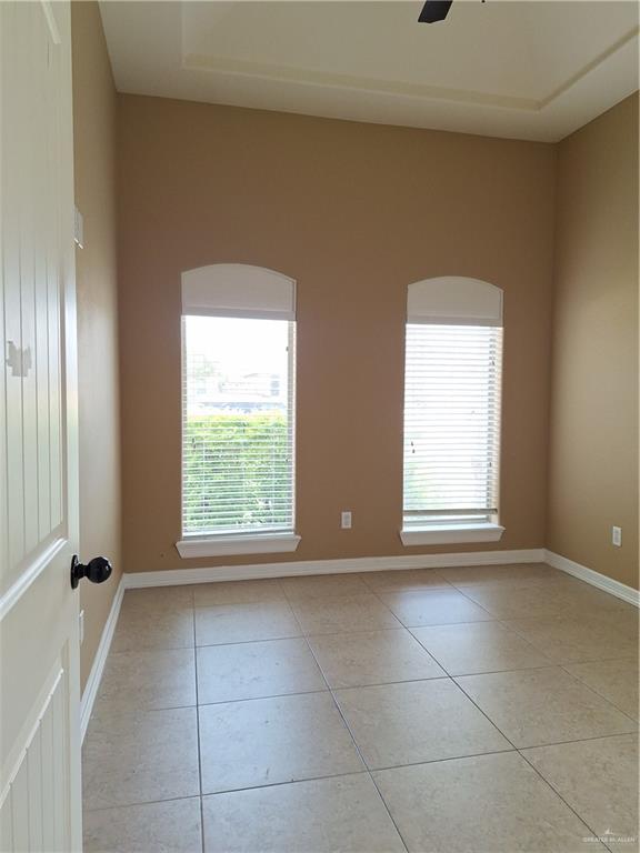 2212 North Ruby Street Edinburg, TX 78541 - Photo 3 of 11 Bedroom 3 featuring baseboards and light tile patterned floors