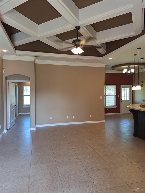 2212 North Ruby Street Edinburg, TX 78541 - Photo 4 of 11 Unfurnished room with coffered ceiling, beam ceiling, healthy amount of natural light, crown molding, and arched walkways