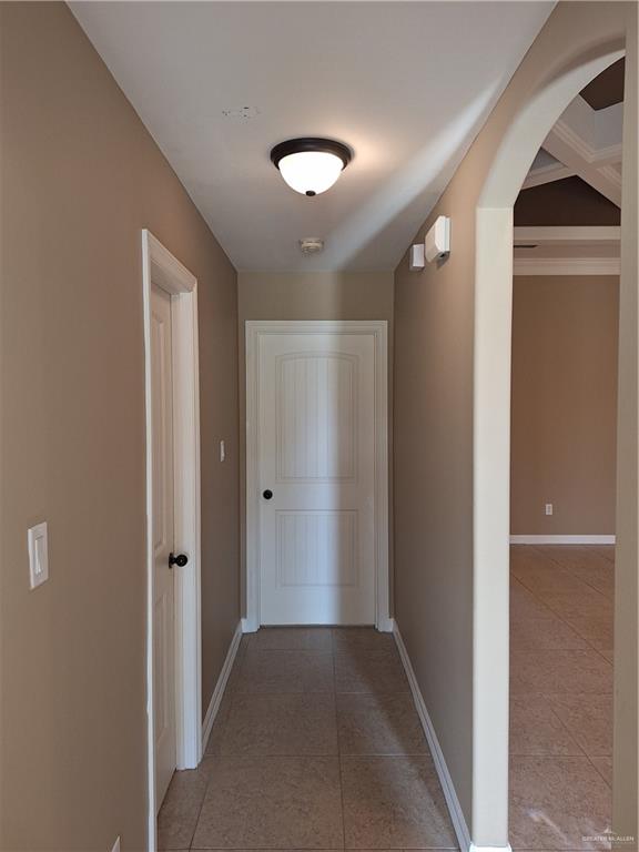 2212 North Ruby Street Edinburg, TX 78541 - Photo 5 of 11 Hallway with light tile patterned flooring and arched walkways