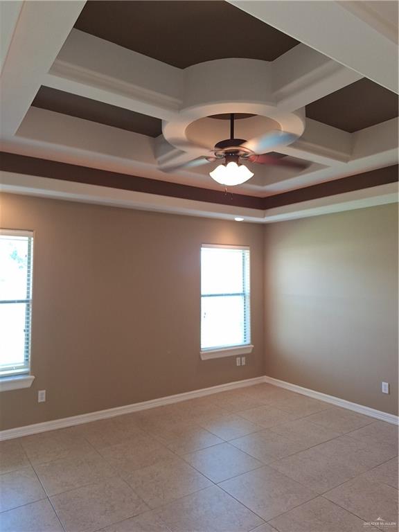 2212 North Ruby Street Edinburg, TX 78541 - Photo 10 of 11 Empty room featuring coffered ceiling, ceiling fan, beam ceiling, and light tile patterned floors