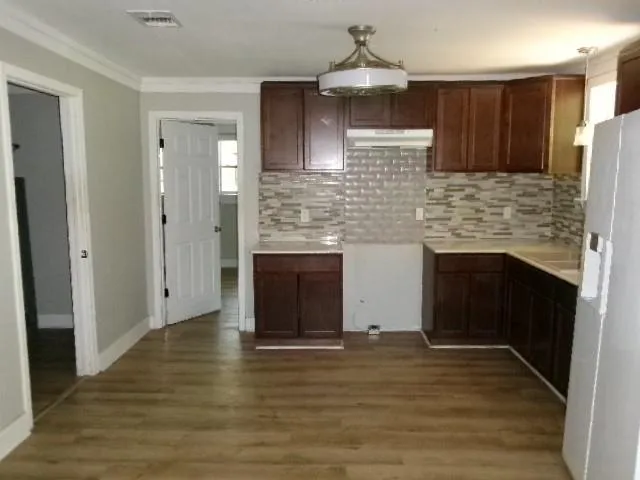 a kitchen with stainless steel appliances a stove and a refrigerator