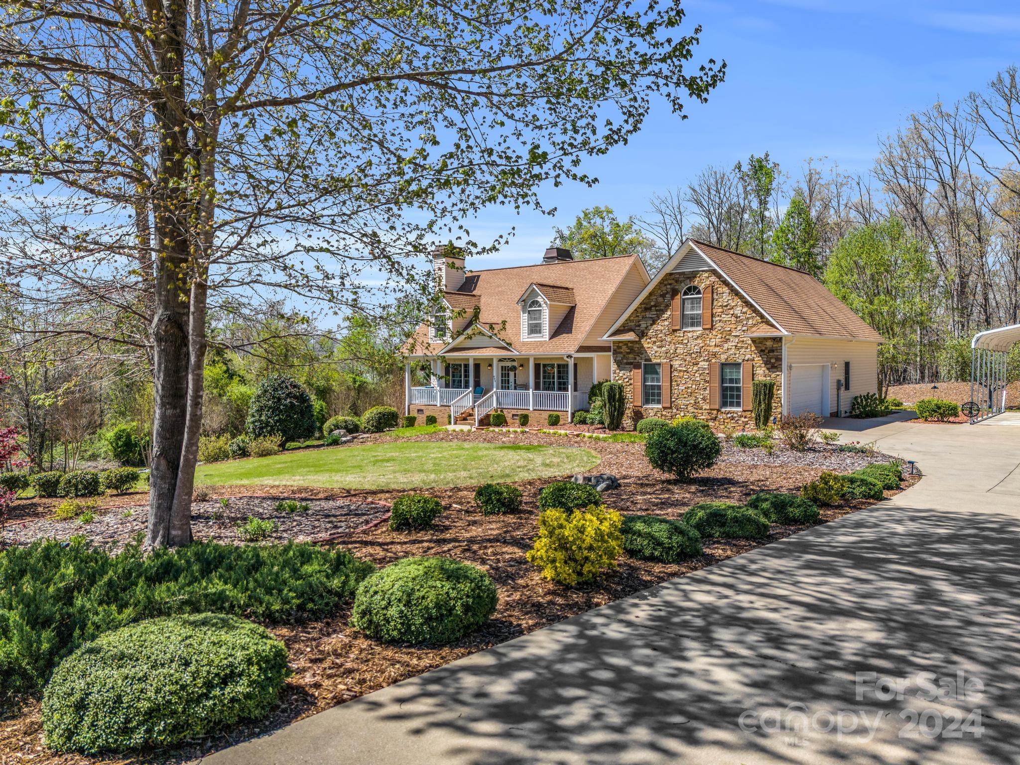 699 Jj Guffey Road Rutherfordton, NC 28139 - Photo 5 of 44 a front view of a house with garden