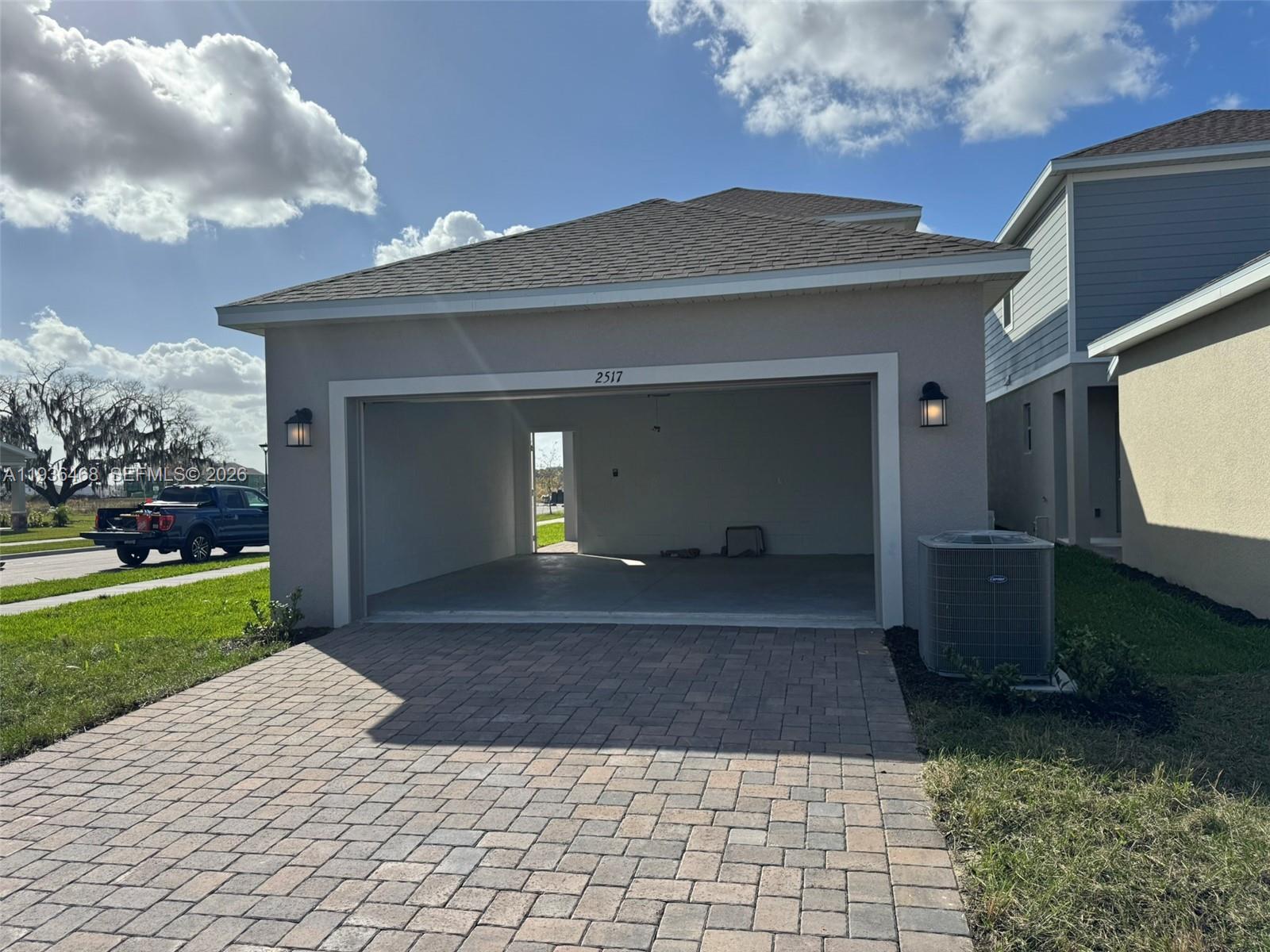 2517 Spring Tune Alley Kissimmee, FL 34744 - Photo 4 of 16 a front view of a house with a yard and a garage