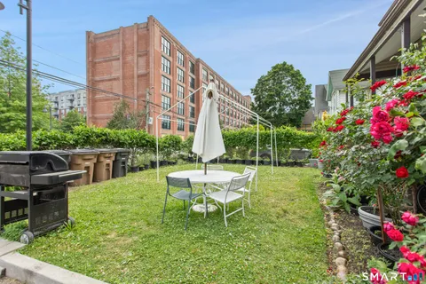 a view of a chair and tables in the backyard of the house